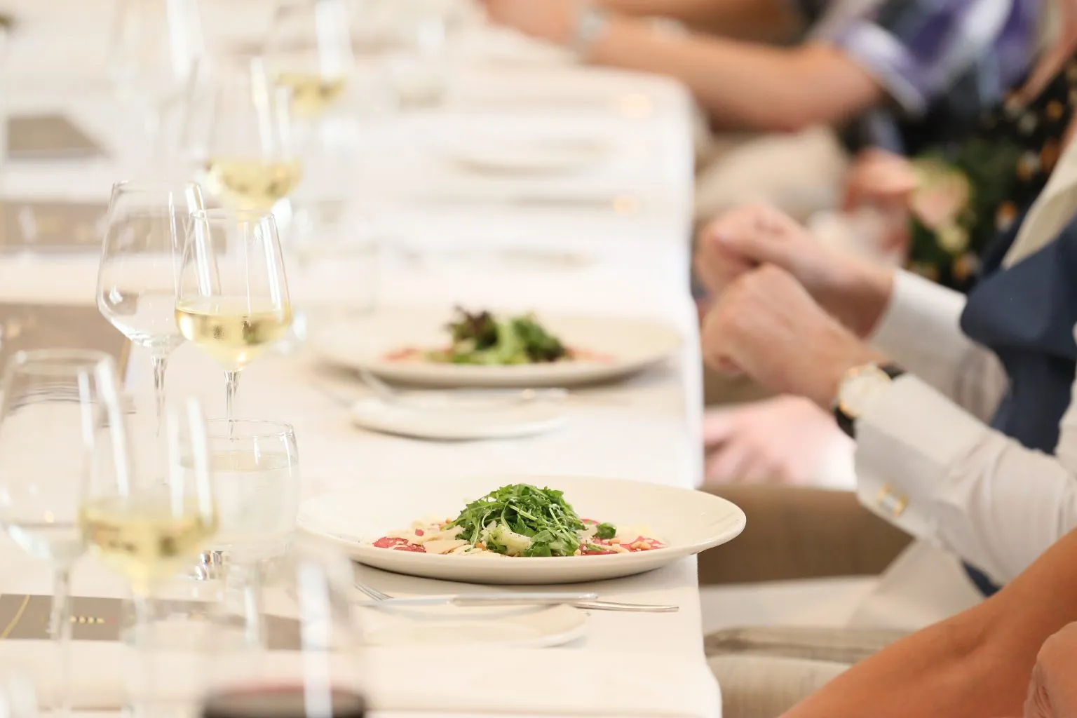 Lange gedekte tafel met gasten aan het diner bij Parkhotel Horst