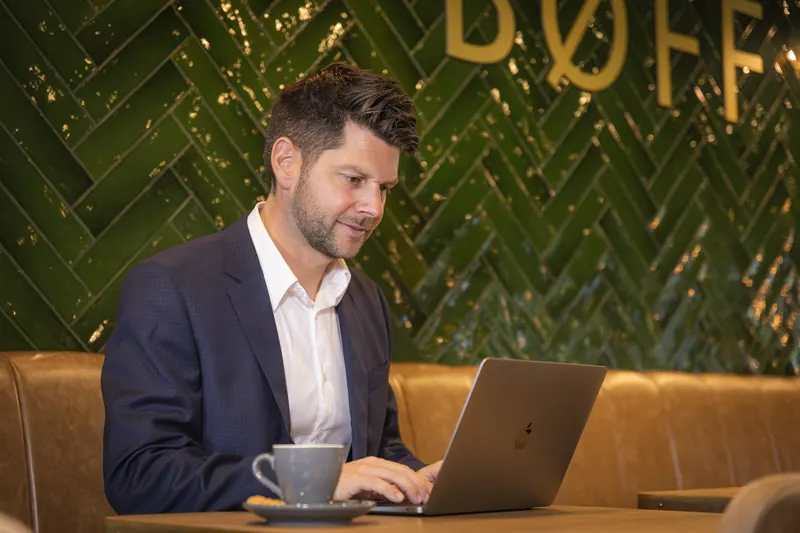 A guest works on a laptop in restaurant BØFF