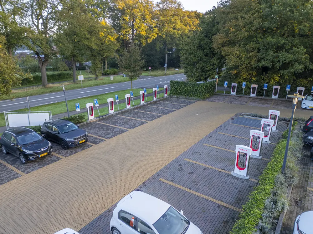The row of Tesla Superchargers in the car park, from above