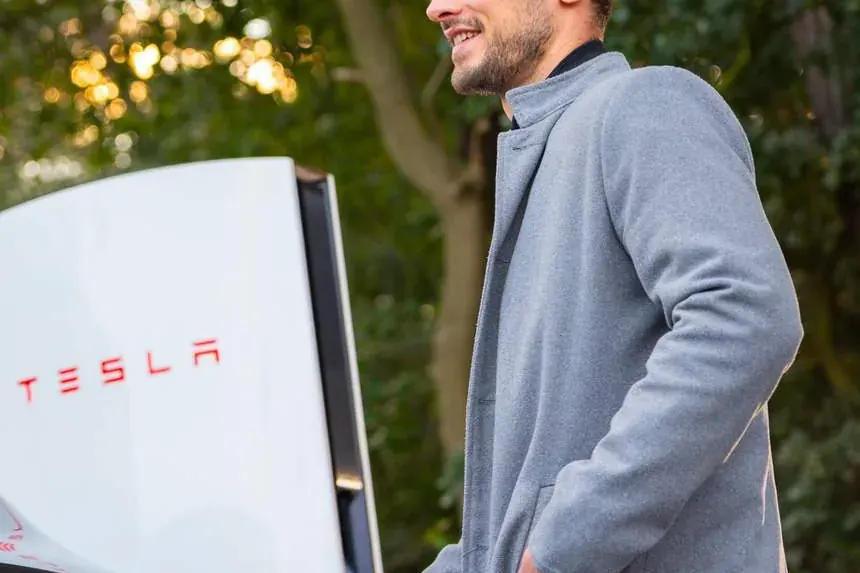 A guest charging his car at a Tesla Supercharger