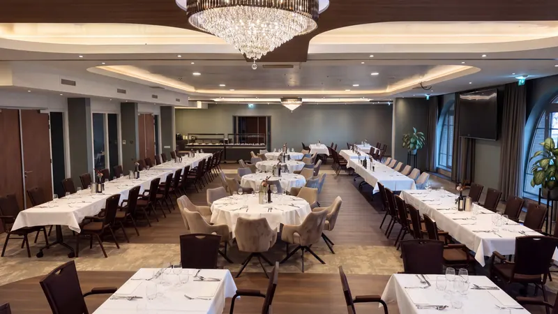 Een feestelijk gedekte zaal met kroonluchter