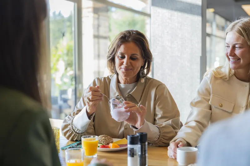 Guest enjoying yoghurt at the breakfast table of Parkhotel Horst